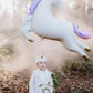 child with leaping unicorn balloon