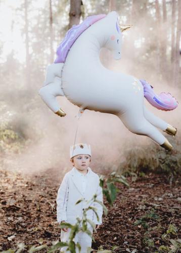 child with leaping unicorn balloon