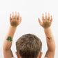 Boy with DInosaur tattoos on armsi